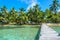 Tobacco Caye - Relaxing on Wooden Pier on small tropical island at Barrier Reef with paradise beach, Caribbean Sea, Belize,