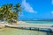 Tobacco Caye - Relaxing on Wooden Pier on small tropical island at Barrier Reef with paradise beach, Caribbean Sea, Belize,