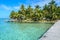 Tobacco Caye - Relaxing on Wooden Pier on small tropical island at Barrier Reef with paradise beach, Caribbean Sea, Belize,