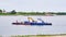 Tobolsk, Russia Barge with cars, special vehicles and people swims along the Irtysh river. Banner