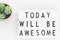 `Today will be awesome` words on a lightbox over white background, overhead view