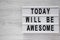 `Today will be awesome` words on modern board over white wooden background, top view. Overhead, flat lay, from above. Copy space