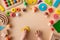 Toddler activity for motor and sensory development. Baby hands with colorful wooden toys on light table top view