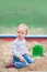 Toddler activity on playground in sandbox