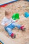 Toddler activity on playground in sandbox