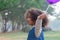 Toddler Afro girl play the colorful balloon in park alone, Color skin girl with unique hairstyle enjoy lifestyle with nature