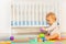 Toddler baby boy build pyramid in nursery room