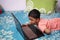 a toddler baby boy engaged in watching and exploring laptop.Screen time addiction concept image