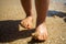 Toddler baby feet on the sand beach. Vacation and travel with small children concept