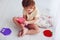Toddler baby girl playing with colorful sensory toys. pushing the bubbles on pop it fidget toy
