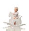 Toddler baby girl is riding swinging on a rocking chair toy horse over white
