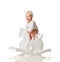 Toddler baby girl is riding swinging on a rocking chair toy horse over white