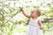 Toddler baby girl with spring flowers