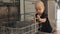 toddler baby kid black shirt playing opened dishwasher touching plastic bin