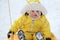 Toddler baby rides in the snow on icesled, a winter playground. Mother