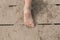 Toddler bare foot on wooden deck at the beach