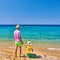 Toddler boy on beach with father