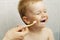 Toddler boy brushes teeth