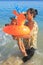 Toddler boy carried by mom in sea