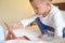 toddler boy child sitting in bed playing with tablet pc