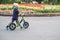 Toddler boy child wearing safety helmet learning to ride first balance bike