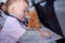 Toddler boy coloring in coloring book with crayons during flight on airplane