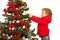 Toddler boy decorate Christmas tree