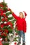 Toddler boy decorate tree