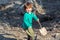 Toddler boy digging with a shovel