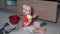 Toddler boy eat food sitting in mess on kitchen floor