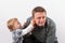 Toddler boy inspecting his father`s hearing aid in his ear