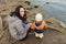 Toddler boy with mom standing by river