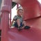 Toddler Boy Perched at the Top of a Slippery Slide