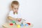 A toddler boy playing with kinetic sand, a great activity to develop fine motor skills