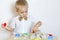A toddler boy playing with kinetic sand, a great activity to develop fine motor skills