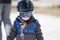 Toddler Boy Ready to Ski with all Safety Gear. Helmet & Harness.