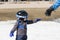 Toddler Boy Ready to Ski Dressed for Safety with Helmet & Harness