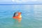 Toddler boy sailing inflating ring on sea
