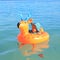 Toddler boy sailing inflating ring on sea