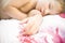 Toddler boy sleeping under beach umbrella shade