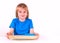 Toddler boy standing with a tray of Montessori materials for a lesson on a white background. Exercise cutting with scissors.