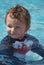 Toddler Boy Swimming in pool