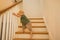 Toddler boy is training new skills on stairs