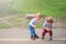 Toddler boys walk and play outside in spring