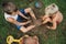 Toddler brothers sitting in a grass having fun playing with mud