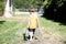 Toddler carrying his milk from farm