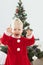 Toddler child with cochlear implant plays near christmas tree - deafness and innovating medical technologies for hearing