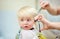 Toddler child getting his first haircut