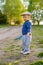 Toddler child outdoors. Rural scene with one year old baby boy wearing flat cap