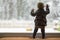 Toddler child standing in front of a big window leaning against